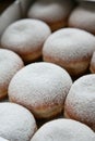 Several traditional german donuts with powdered sugar and a napkin on top. Top view. Good food, good mood.