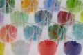 several transparent colored plastic resin granulates in test glasses