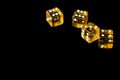 Several transparent yellow dice on a black surface closeup. Gambling ÃÂoncept background