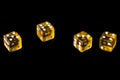 Several transparent yellow dice on a black surface closeup. Gambling ÃÂoncept background