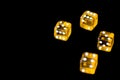 Several transparent yellow dice on a black surface closeup. Gambling ÃÂoncept background