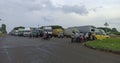 Several trucks are parked on the highway in an industrial area