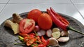 Several types of ingredients on a mortar that is ready to be mashed into chili sauce. Royalty Free Stock Photo