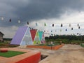 several unique, colorful houses with several relaxing pillows in their yard and decorative hangings