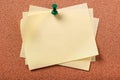 Several untidy yellow sticky post notes pinned to cork board background Royalty Free Stock Photo