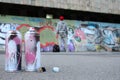 Several used spray cans with pink and white paint lie on the asp Royalty Free Stock Photo