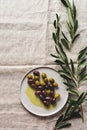 Several Varieties Of Fresh Olives In Different Ceramic Plates On An Old Vintage Gray Napkin Tablecloth Table Background. Natural P