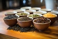 several varieties of loose-leaf tea in small, stacked bowls Royalty Free Stock Photo