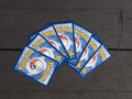 Several very popular Pokemon cards on dark wooden background