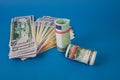 several wads of money of different currencies on a blue background Royalty Free Stock Photo