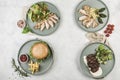 Several warm dishes with chicken, turkey, beef fillets and pork cutlet burgers in different plates Royalty Free Stock Photo