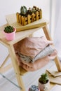 Warm sweaters lie on a wooden shelf