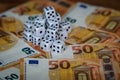 Several white dice and euro money Royalty Free Stock Photo