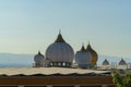 several white middle eastern domes on rooftop