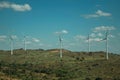 Several wind turbines over hilly landscape