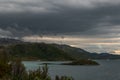 Several windmills on the Norwegian coastline. Dramatic clouds on the sky