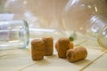 Several wine corks and glass flasks laboratory stand on wooden surface close Royalty Free Stock Photo
