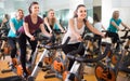 Several women of different age training on exercise bikes Royalty Free Stock Photo