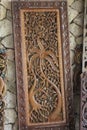 Several wood carving crafts with various shapes are displayed on the terrace of a hotel in Lombok, Indonesia