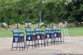 Several wooden chairs with numbers on outdoor, competitive exam concept