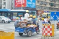 Several workers sitting in the electric tricycle in the street