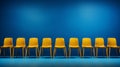 Several yellow chairs are arranged in a row against a blue background in this yellow and amber-inspired image