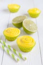 Several yellow cupcakes in paper liners