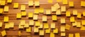 Yellow Postit notes on wooden wall create a colorful display Royalty Free Stock Photo