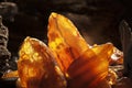 Beauty of natural amber. Several yellow natural amber stones in a cave.