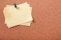 Several yellow sticky post notes pinned pushpin cork board background Royalty Free Stock Photo