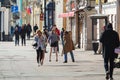 Several young beautiful girls walk along Nevsky Prospekt and take photos