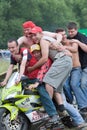 Several young caucasian peoples on one motorbike