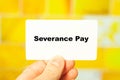 Severance Pay. Financial text in male hand on yellow background at home