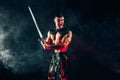 Severe barbarian in leather costume with sword Royalty Free Stock Photo