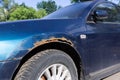 Severe corrosion on the old blue car
