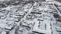 Severe snowy winter in a village in the far north, small wooden houses in the snow. Aerial view, shooting from a drone.