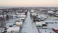 Severe snowy winter in a village in the far north, small wooden houses in the snow. Aerial view, shooting from a drone.