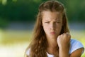 Severe teenage girl shakes her fist
