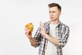 Severe young man holding burger, showing stop gesture with palm isolated on white background. Proper nutrition or