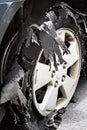 Severely Blown-out Tire with rubber ripped to shreds.
