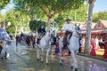 Riders and People dressed in traditional costumes enjoy April Fair. Seville Fair Feria de Sevilla Royalty Free Stock Photo