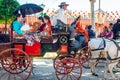 Spanish families in traditional dress travelling in a horse drawn carriages at the April Fair, Seville Fair Royalty Free Stock Photo