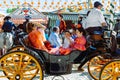 Spanish families in traditional dress travelling in a horse drawn carriages at the April Fair, Seville Fair Royalty Free Stock Photo