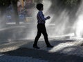 Child in fountain spray Royalty Free Stock Photo