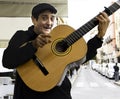 Seville, Andalusia, Spain -29 nov,2019: A street musician in black jacket plays on the guitar. Street guitarist in Seville. Flamen