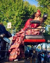 Beautiful woman in traditional and colorful dress travelling in a horse drawn carriages at the April Fair, Seville Fair