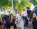 Beautiful Women riding horses and celebrating Seville`s April Fair, Seville Fair Feria de Sevilla. Royalty Free Stock Photo