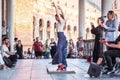 Seville, Spain - April 11, 2023: Flamenco dancer woman accompanied by street buskers guitarists Plaza de EspaÃÂ±a galleries