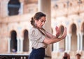 Seville, Spain - April 11, 2023: flamenco dancer woman accompanied by street buskers guitarists on the Plaza de EspaÃÂ±