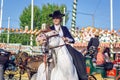 Young Beautiful and Attractive Woman riding andalusian Horse Pure Spanish Horse and celebrating Seville`s April Fair Royalty Free Stock Photo